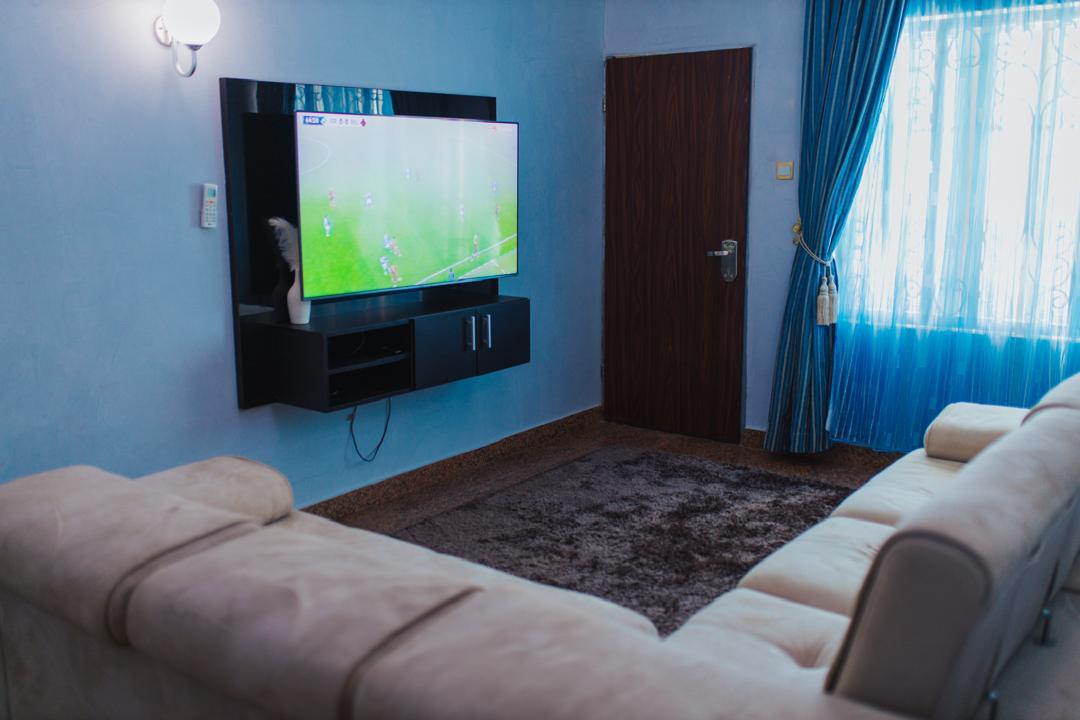 Blue family lounge with a wall-mounted TV